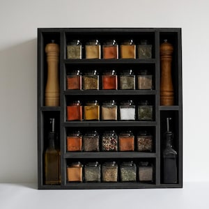 Black spicerack with 25 spice jars and salt & pepper grinder