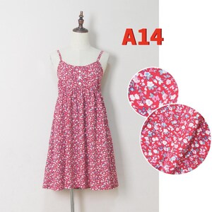 May include: A red floral print dress with spaghetti straps. The dress features a fitted bodice and a flared skirt. The fabric is covered in a pattern of small white, blue, and pink flowers. The text "A14" is in the upper right corner.
