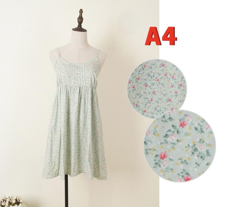 May include: A light green floral print dress with spaghetti straps displayed on a mannequin. The dress has a gathered bodice and a flared skirt. Two circular fabric swatches with the same floral pattern are shown next to the dress. The text "A4" is in the upper right corner.