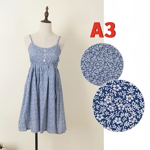 May include: A blue floral print sundress with spaghetti straps and a button-down front. The dress is displayed on a mannequin. Two fabric swatches with the same floral pattern are shown to the right, and the text "A3" is in the upper right corner.