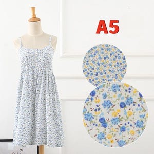 May include: A white sundress with a blue floral pattern, displayed on a mannequin. The dress has thin straps and a gathered bodice. Two circular fabric swatches with the same floral print are shown next to the dress. The number "A5" is displayed in red.