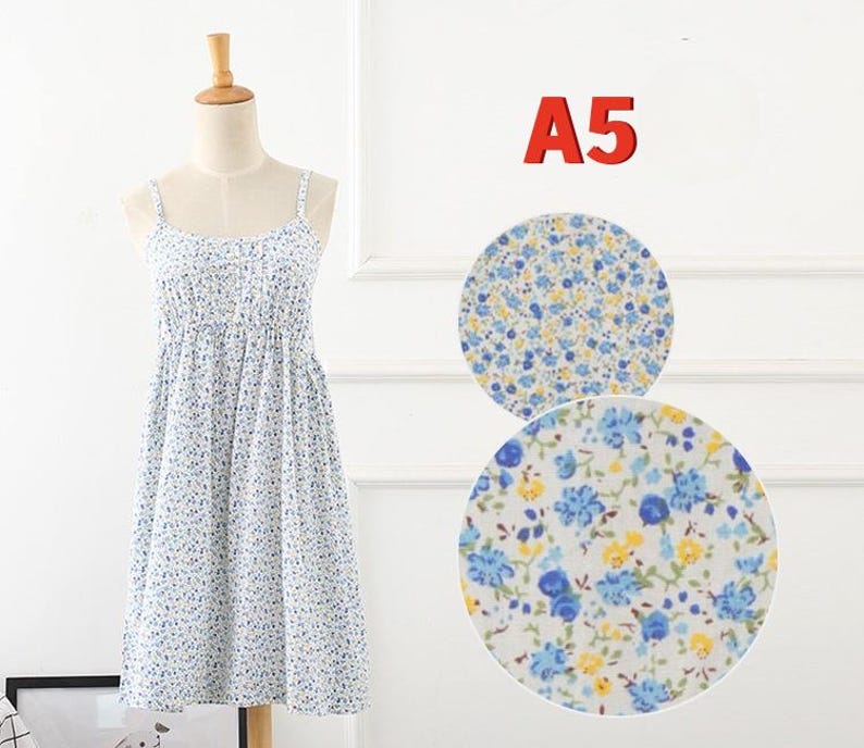 May include: A white sundress with a blue floral pattern, displayed on a mannequin. The dress has thin straps and a gathered bodice. Two circular fabric swatches with the same floral print are shown next to the dress. The number "A5" is displayed in red.