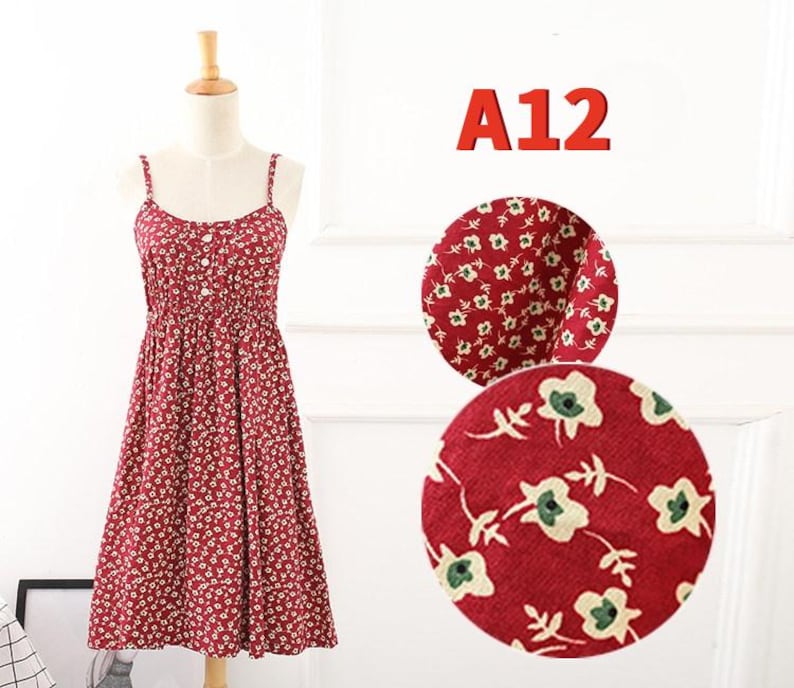 May include: A red floral print sundress with spaghetti straps and a button-down bodice. The dress is displayed on a mannequin. The text "A12" is in red. Two circular fabric swatches show the floral pattern.