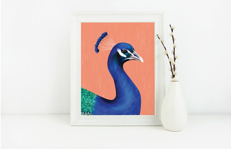 May include: A framed print of a peacock with a blue head and neck, a green and blue body, and a white crest. The background is a peach color.