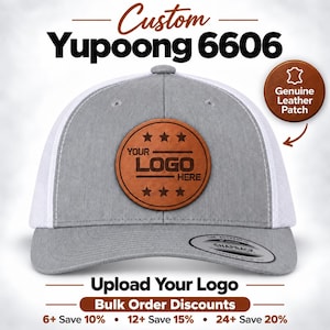 May include: A grey and white trucker hat featuring a circular brown genuine leather patch on the front panel. The patch displays the text YOUR LOGO HERE with three stars above and below. A black sticker on the brim reads THE AUTHENTIC SNAPBACK.