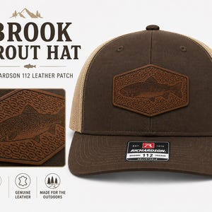 May include: A brown trucker hat with a tan mesh back and a hexagonal leather patch featuring an embossed brook trout design. The front of the hat displays a black and white sticker with the text Richardson 112 Trucker Adjustable.
