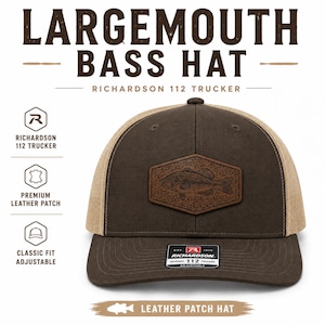 May include: A brown and tan Richardson 112 trucker hat featuring a hexagonal leather patch with an embossed largemouth bass fish design. The hat has a solid brown front panel, a mesh back, and a sticker on the brim reading Richardson 112.
