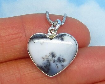 May include: A silver heart-shaped pendant with a white and black dendritic agate stone.
