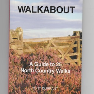 May include: A book cover with the title "WALKABOUT" and the subtitle "A Guide to 25 North Country Walks" by Tony Durrant. The cover features a photograph of a wooden gate and purple heather.