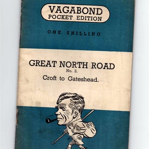 May include: A vintage "Vagabond Pocket Edition" book cover. The cover is blue and white with the text "Great North Road No. 2. Croft to Gateshead." A cartoon illustration of a man with a pipe and a walking stick is featured.