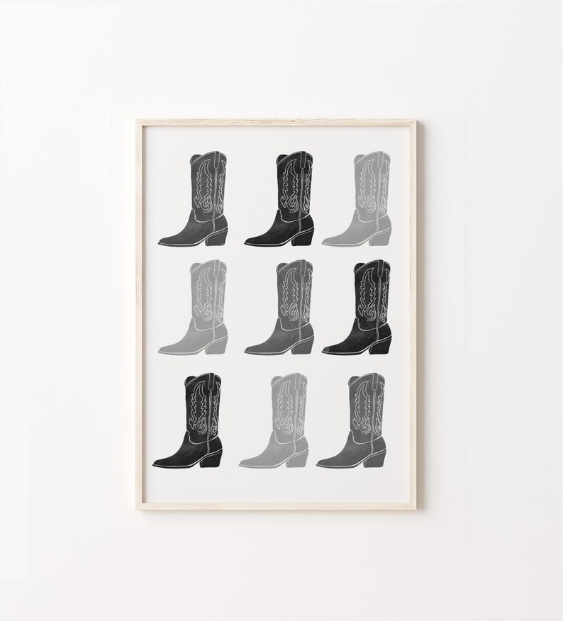May include: A black and white print of nine cowboy boots in a repeating pattern. The boots are arranged in three rows of three. The boots are all the same style, but they are different shades of gray. The boots are all facing the same direction.