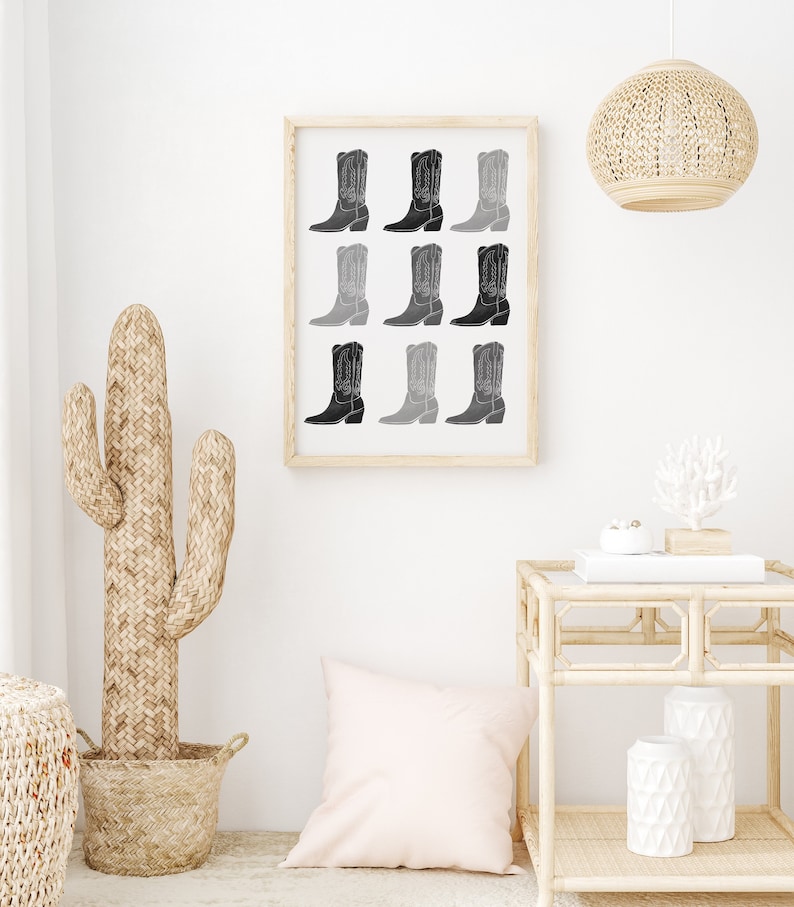 May include: A framed print of a black and white illustration of nine cowboy boots in a gradient pattern.