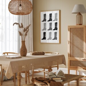 May include: A dining room with a wooden table and chairs, a woven light fixture, a framed print of black and white cowboy boots, a woven side table, and a woven cabinet.