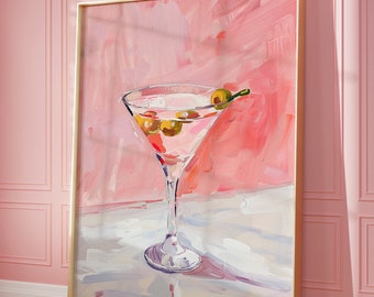 May include: A framed art print depicting a martini cocktail with olives. The painting shows a clear glass with a pink drink and green olives. The background is a textured pink and white abstract design.