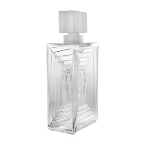 May include: A clear glass decanter with a frosted glass stopper. The decanter has a rectangular shape with a textured design and a raised image of two figures.