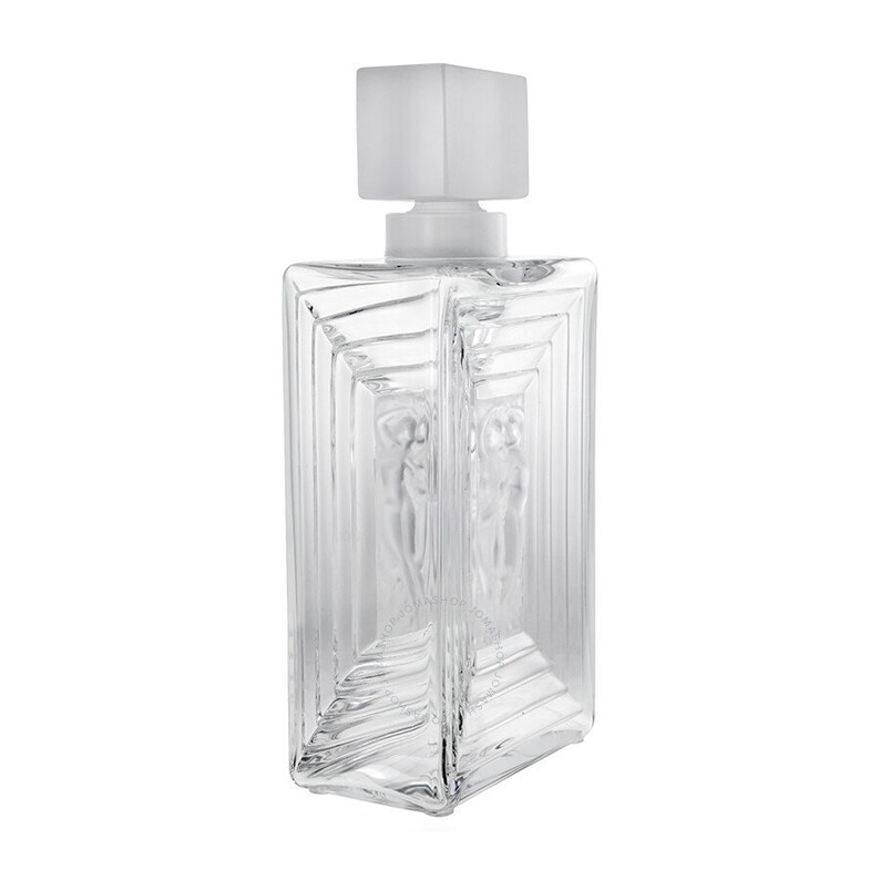 May include: A clear glass decanter with a frosted glass stopper. The decanter has a rectangular shape with a textured design and a raised image of two figures.