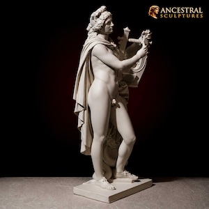 May include: A classical white sculpture of a nude male figure playing a lyre. The figure is draped with a cloth and stands on a rectangular base. The sculpture is set against a dark background with the text "ANCESTRAL SCULPTURES" in the upper right corner.