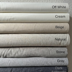 May include: A stack of fabric swatches in various shades of beige, gray, and white. The swatches are labeled with the following names: Off White, Cream, Beige, Natural, Stone, Gray, and Dark Anthracite.