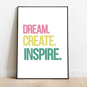 May include: A framed print with the text "DREAM. CREATE. INSPIRE." in pink, yellow, and green.