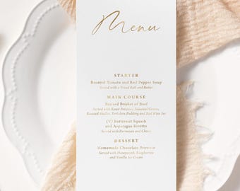 May include: A white menu card with gold lettering, listing a starter, main course, and dessert. The menu includes Roasted Tomato and Red Pepper Soup, Braised Brisket of Beef, and Homemade Chocolate Brownie.