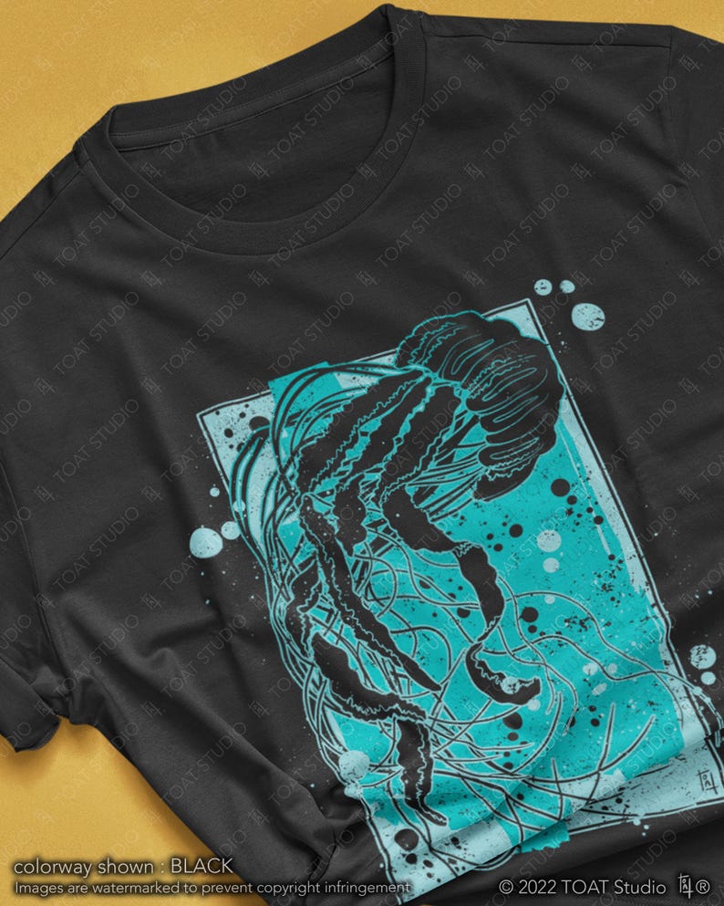 May include: Black t-shirt with a graphic print of a jellyfish in a turquoise and black color scheme. The jellyfish is surrounded by a blue and white background with a white border.