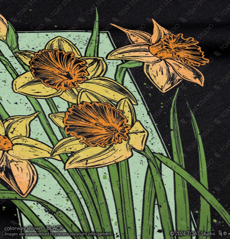 May include: A black t-shirt with a graphic print of yellow and orange daffodils with green stems and leaves on a black background.