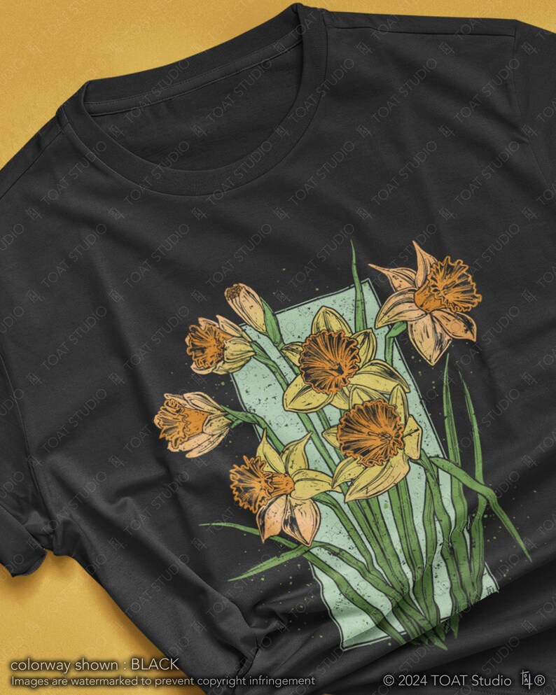 May include: A black t-shirt with a vintage-style illustration of a bouquet of yellow daffodils on a dark background.