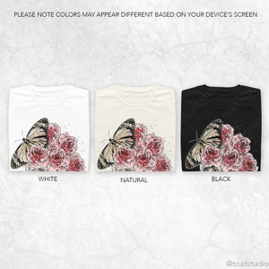 May include: Three t-shirts in white, natural, and black, each featuring a butterfly and rose design. The butterfly has tan and black wings, and the roses are pink. The text "WHITE", "NATURAL", and "BLACK" are below each shirt.