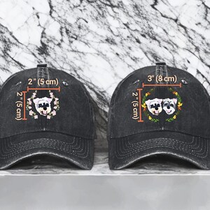May include: Two black denim baseball caps with embroidered dog faces. The cap on the left has one dog face, and the cap on the right has two dog faces. The caps are 2 inches (5 cm) wide and 3 inches (8 cm) wide.