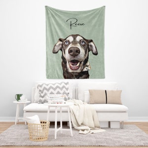 May include: A green fleece throw blanket with a personalized illustration of a dog with the name "Reese" written in cursive on the top.