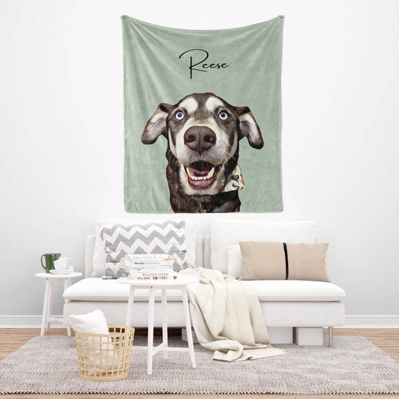 May include: A green fleece throw blanket with a personalized illustration of a dog with the name "Reese" written in cursive on the top.