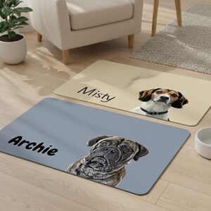 May include: Two rectangular pet mats with dog portraits and names. One is beige with "Misty" and a beagle. The other is gray with "Archie" and a mastiff. A white dog bowl sits nearby.