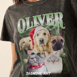 Op de afbeelding: Een zwart T-shirt met een distressed look met het woord "OLIVER" in groene letters met een bliksemontwerp. Het shirt heeft een afbeelding van vier honden en twee katten die feestelijke kleding dragen. De tekst "JASMIN ART" staat onderaan de afbeelding.