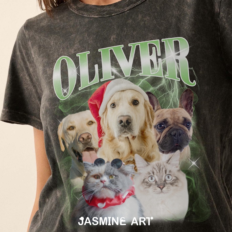 Op de afbeelding: Een zwart T-shirt met een distressed look met het woord "OLIVER" in groene letters met een bliksemontwerp. Het shirt heeft een afbeelding van vier honden en twee katten die feestelijke kleding dragen. De tekst "JASMIN ART" staat onderaan de afbeelding.