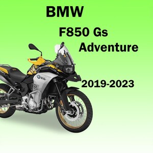 May include: A BMW F850 GS Adventure motorcycle, model years 2019-2023, featuring a black, silver, and yellow color scheme with gold-rimmed wheels, a tall windscreen, hand guards, and the BMW logo on the side panel against a light green background.