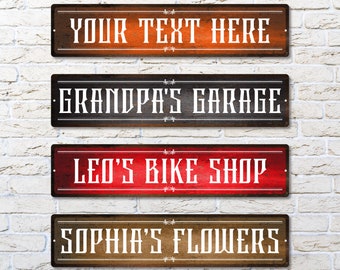 May include: Four rustic wooden signs with white text. The top sign says "YOUR TEXT HERE". The second sign says "GRANDPA'S GARAGE". The third sign says "LEO'S BIKE SHOP". The bottom sign says "SOPHIA'S FLOWERS".