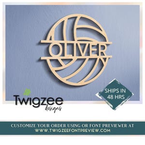 May include: A circular light-colored wooden wall decoration shaped like a volleyball with a horizontal cutout across the center displaying the name OLIVER in capital letters. The design features curved lines mimicking the panels of a ball.
