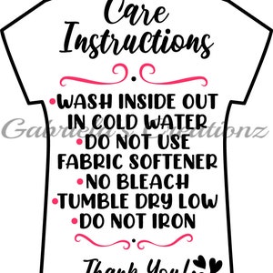 May include: White t-shirt with black text outlining care instructions for washing, drying, and ironing. The text reads "Care Instructions" followed by "Wash inside out in cold water", "Do not use fabric softener", "No bleach", "Tumble dry low", and "Do not iron". The text ends with "Thank You!" and two black hearts.