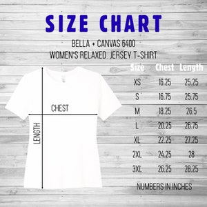 May include: Size chart for women's relaxed jersey t-shirts, showing chest and length measurements in inches for sizes XS to 3XL. The chart is on a woodgrain background.