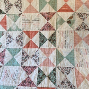 41” x 32”, Baby or toddler handmade girl quilt, bear cubs, moons, flowers, hourglass geometric, white pink mint green.