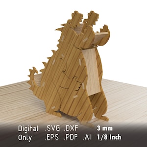 May include: A wooden dinosaur-shaped desk organizer. The light brown, laser-cut design features a detailed, stylized dinosaur with a slot for holding items. The text on the image reads "Digital Only .SVG .DXF .EPS .PDF .AI 3 mm 1/8 Inch".