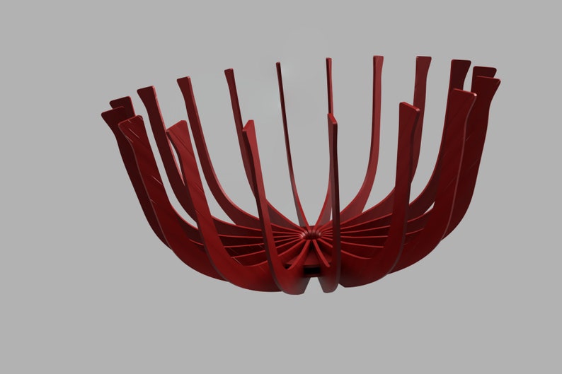 May include: A red metal bowl with a unique design. The bowl is made of many thin, curved pieces of metal that are joined together at the center. The bowl is open at the top and has a wide, shallow base.