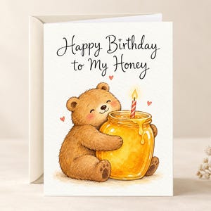 May include: A white greeting card featuring a brown bear hugging a glass jar of golden honey with a single lit candle on top. The text reads Happy Birthday to My Honey in black script, accented by small red hearts surrounding the bear.