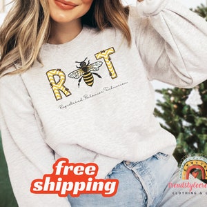 May include: A gray sweatshirt with a bee graphic and the text "RBT Registered Behavior Technician".