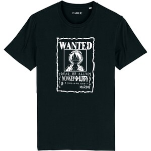 May include: Black t-shirt featuring a white "WANTED" poster design with the image of Monkey D. Luffy. The poster includes the text "DEAD OR ALIVE" and "1,500,000,000 MARINE". The shirt has a crew neck and short sleeves.