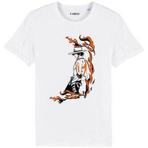 May include: White t-shirt with a black and orange illustration of a character with a straw hat and flames behind them. The character has a tattoo on their arm that says "Ace".