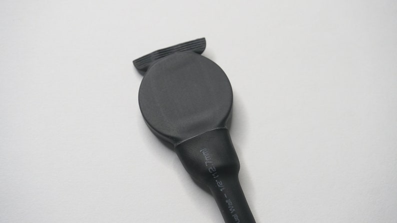 May include: Black heat shrink tubing with a round end cap. The tubing has the text "12-14mm" printed on it.