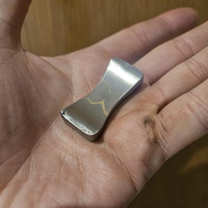 Steel and Brass hourglass worry stone. Steel brass and Haptic coin. Worry stone, haptic stone, touch stone