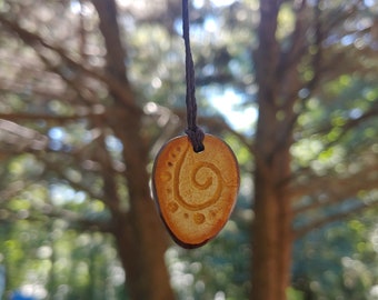 Spiraled carved light colored avocado stone