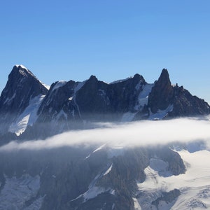 Clouds among mountain peaks in Mont Blanc. Downloadable Full Color Wall Art Print.
